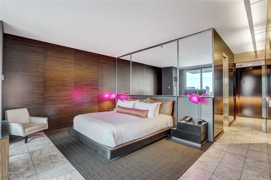 4381 West Flamingo Road, Unit 2202 Las Vegas, NV 89103 - Photo 18 of 40 Bedroom featuring light marble finish flooring and elevator