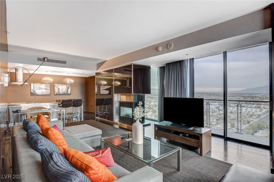 4381 West Flamingo Road, Unit 2202 Las Vegas, NV 89103 - Photo 9 of 40 Living room featuring expansive windows