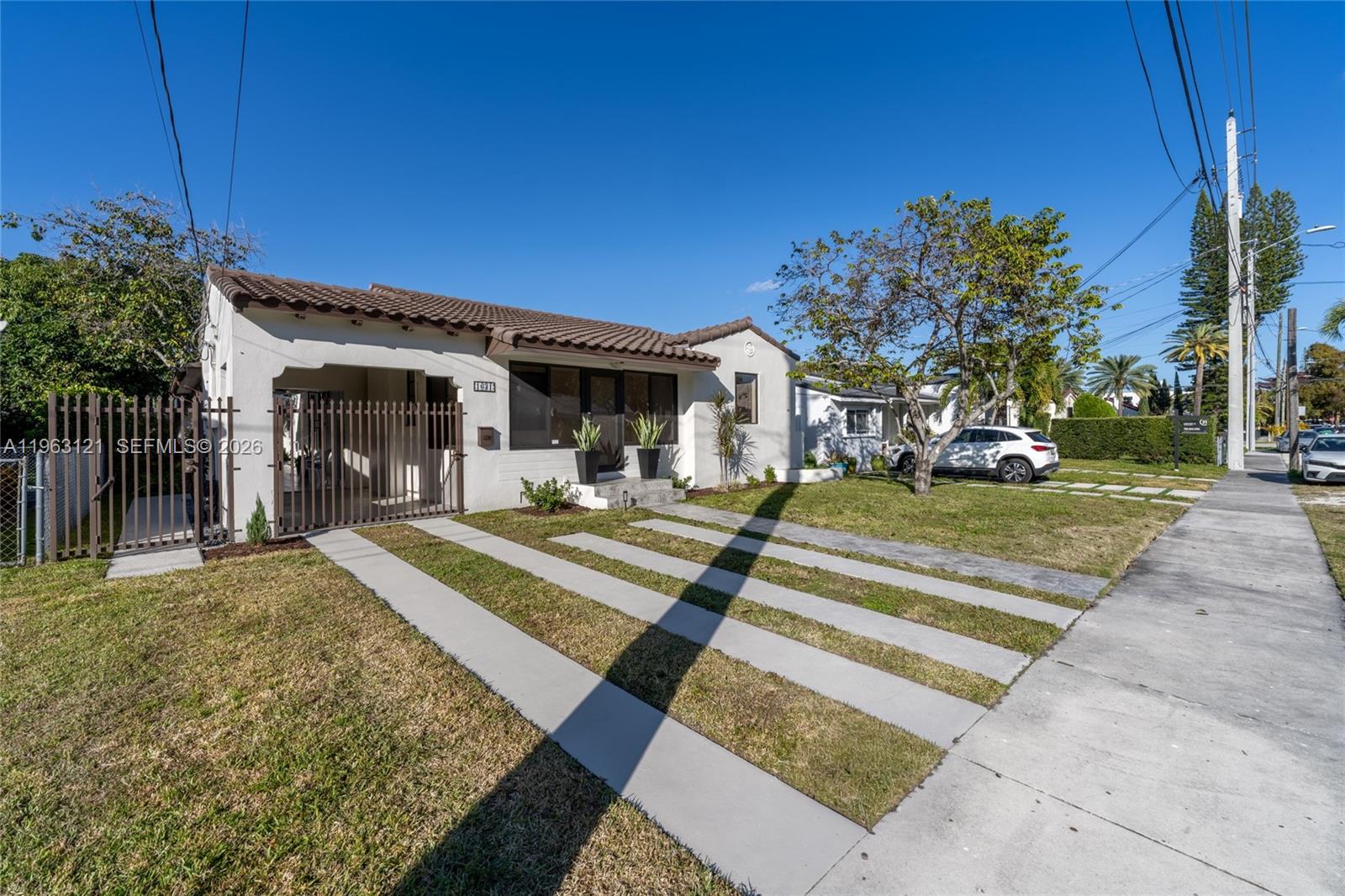 1631 Southwest 21st Street Miami, FL 33145 - Photo 1 of 58 a view of a house with a patio and a yard