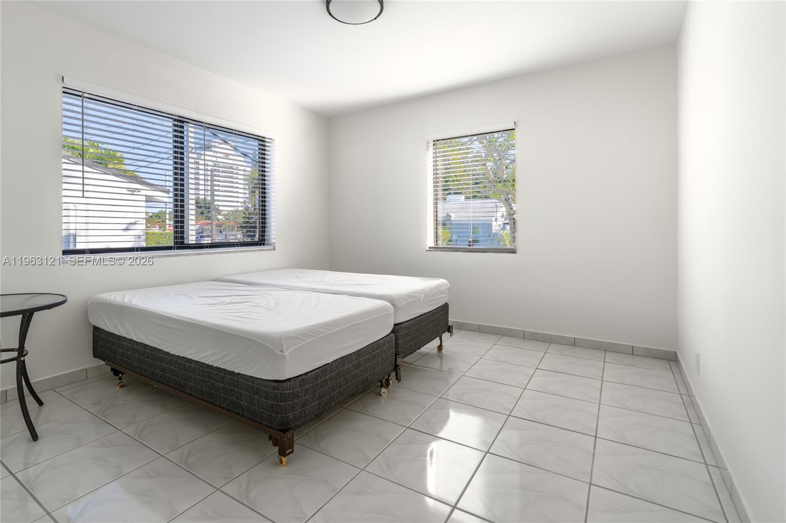 1631 Southwest 21st Street Miami, FL 33145 - Photo 14 of 58 a spacious bedroom with a bed and a window