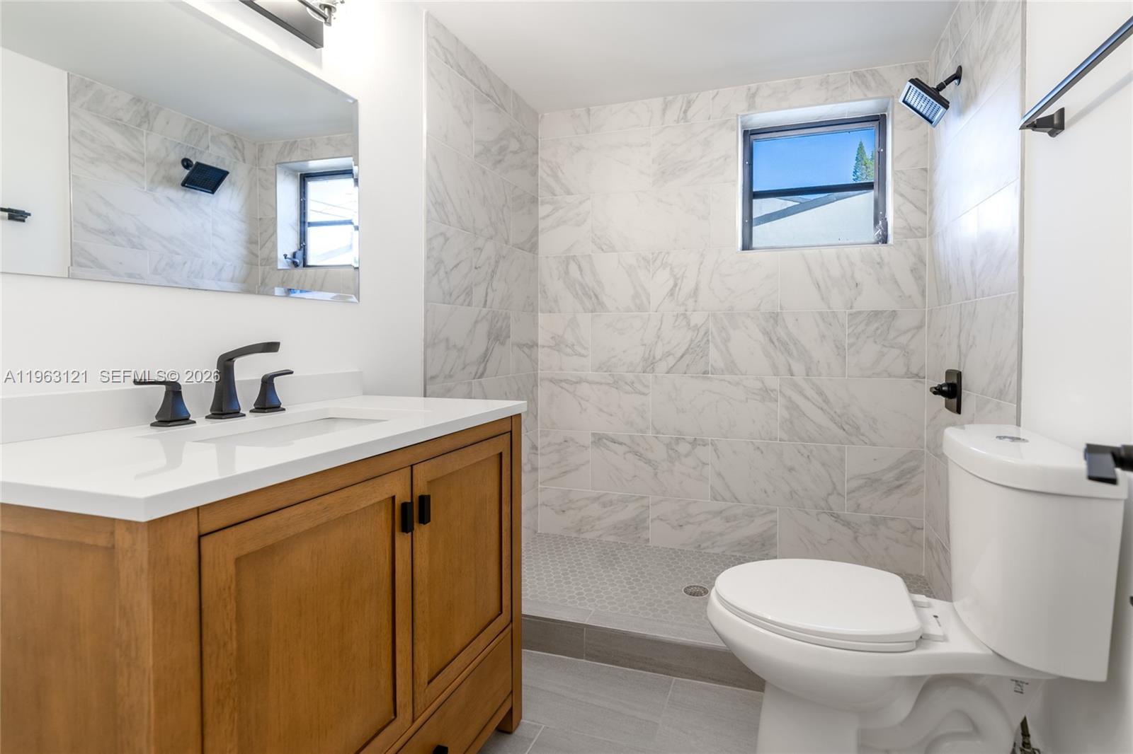 1631 Southwest 21st Street Miami, FL 33145 - Photo 15 of 58 a bathroom with a sink a toilet and shower
