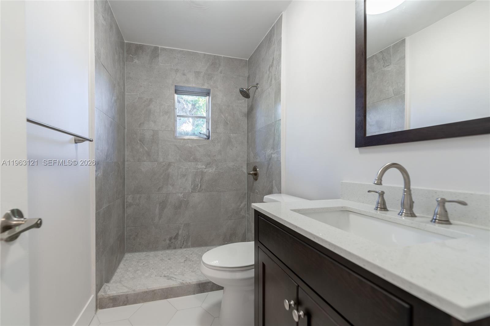 1631 Southwest 21st Street Miami, FL 33145 - Photo 23 of 58 a bathroom with a sink a toilet and shower