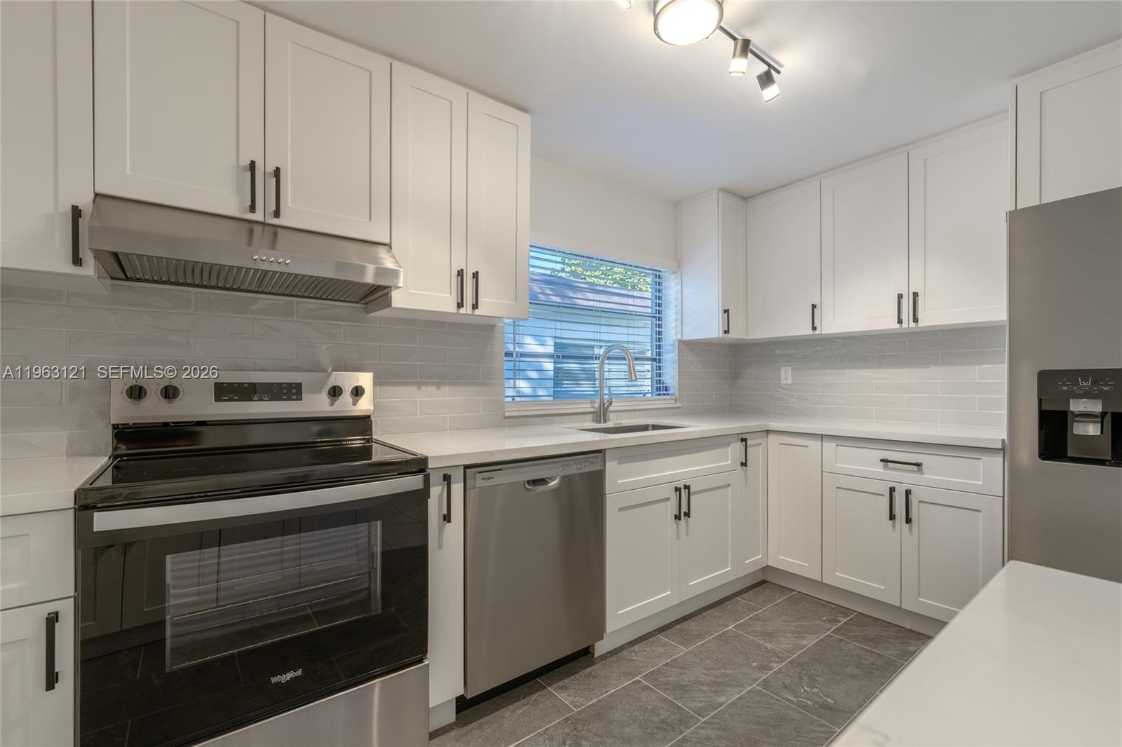 1631 Southwest 21st Street Miami, FL 33145 - Photo 30 of 58 a kitchen with cabinets appliances and a sink