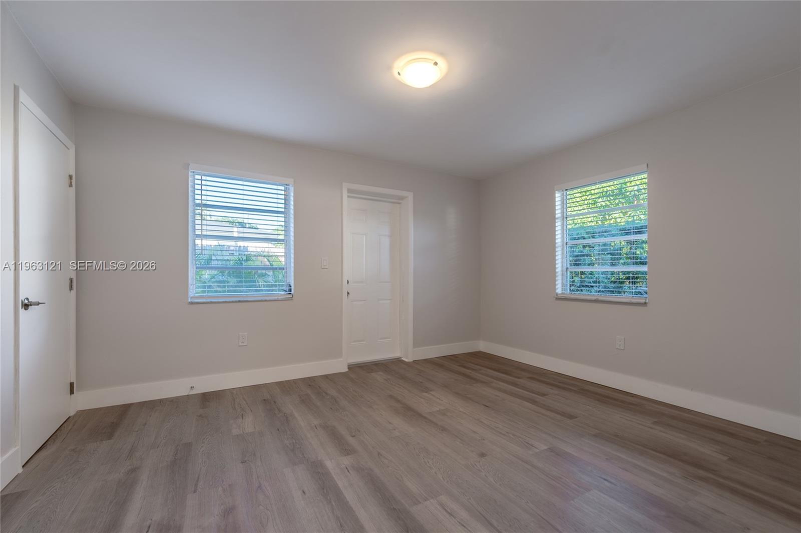 1631 Southwest 21st Street Miami, FL 33145 - Photo 31 of 58 an empty room with wooden floor and windows