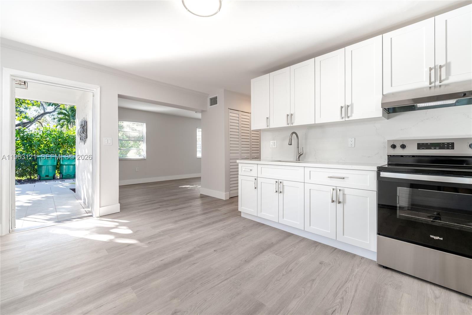 1631 Southwest 21st Street Miami, FL 33145 - Photo 35 of 58 a kitchen with stainless steel appliances granite countertop a stove and a sink