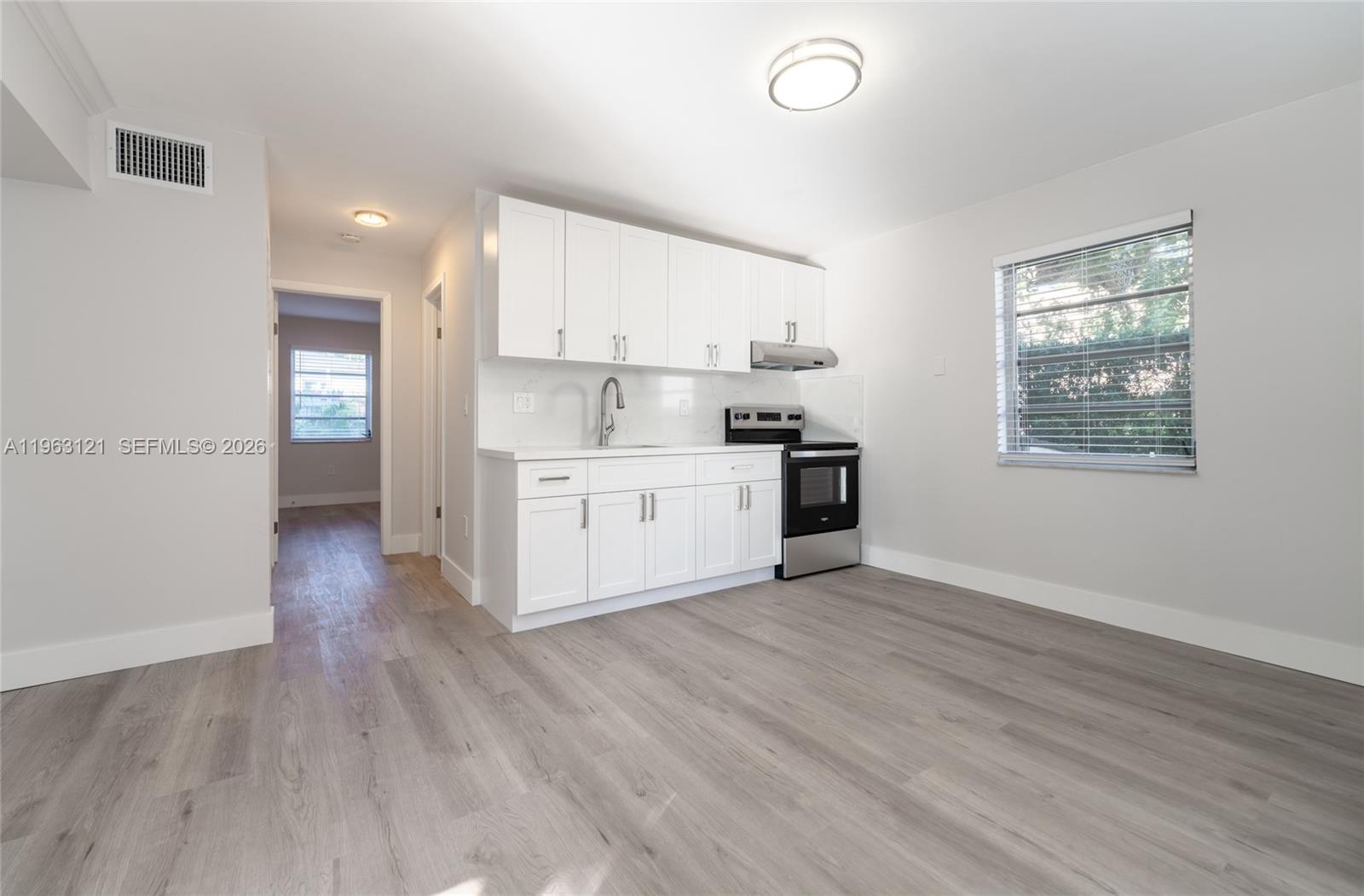 1631 Southwest 21st Street Miami, FL 33145 - Photo 37 of 58 a view of a kitchen with a sink wooden floor and a window