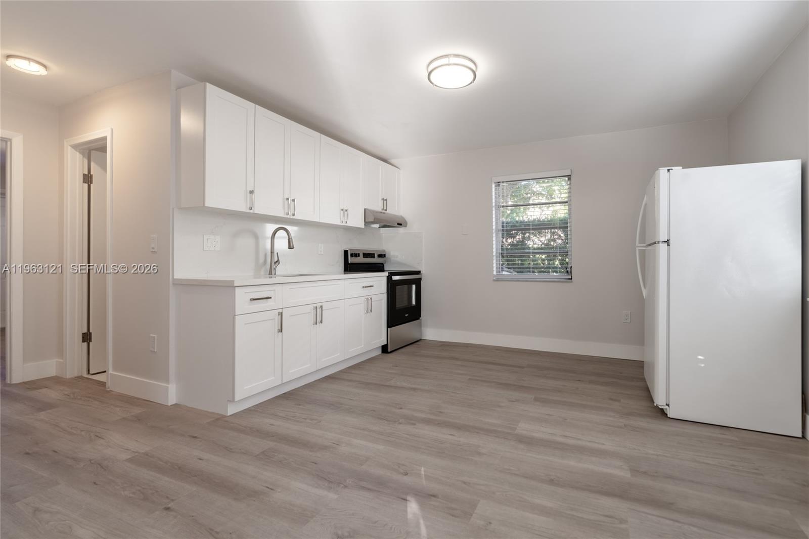 1631 Southwest 21st Street Miami, FL 33145 - Photo 38 of 58 a view of a kitchen with wooden floor and electronic appliances