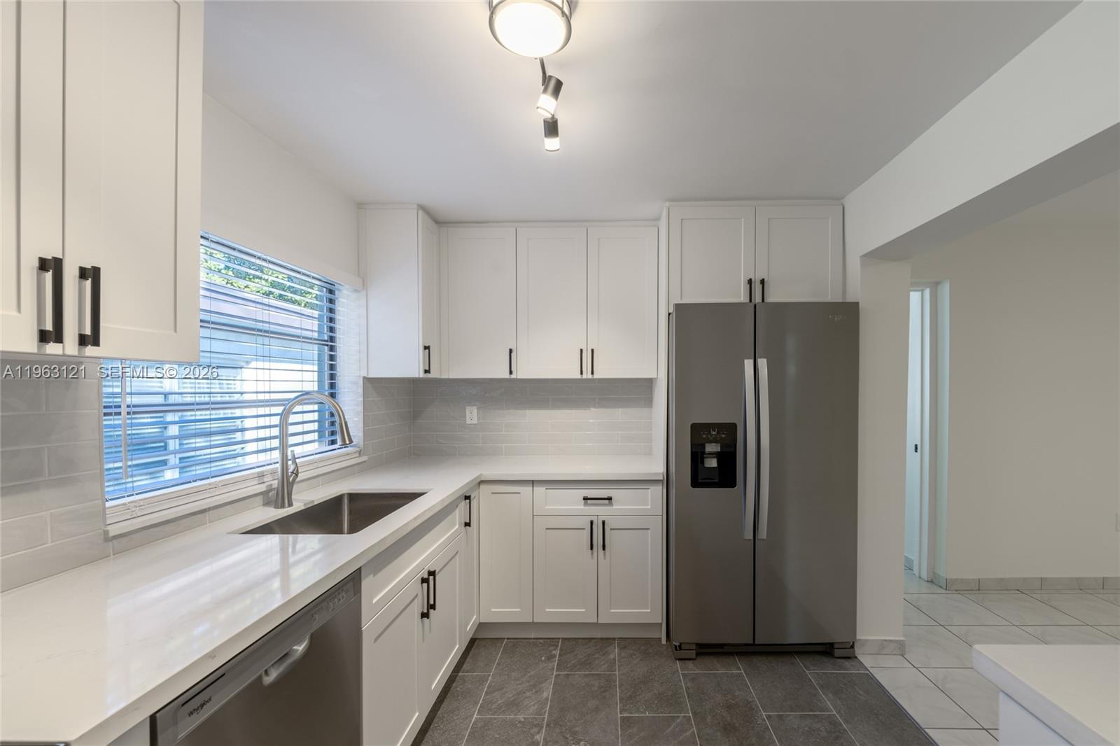 1631 Southwest 21st Street Miami, FL 33145 - Photo 10 of 58 a kitchen with a refrigerator a sink and cabinets
