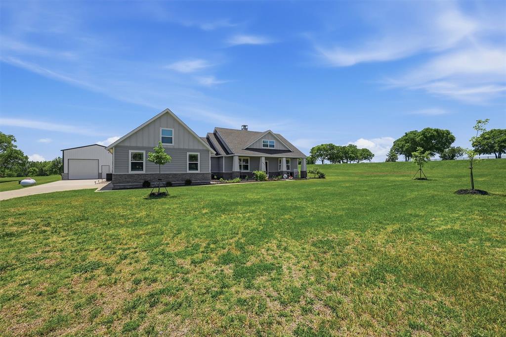 662 Preakness Place Road Van Alstyne, TX 75495 - Photo 2 of 39 a front view of a house with garden