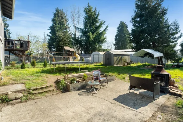 a backyard of a house with table and chairs