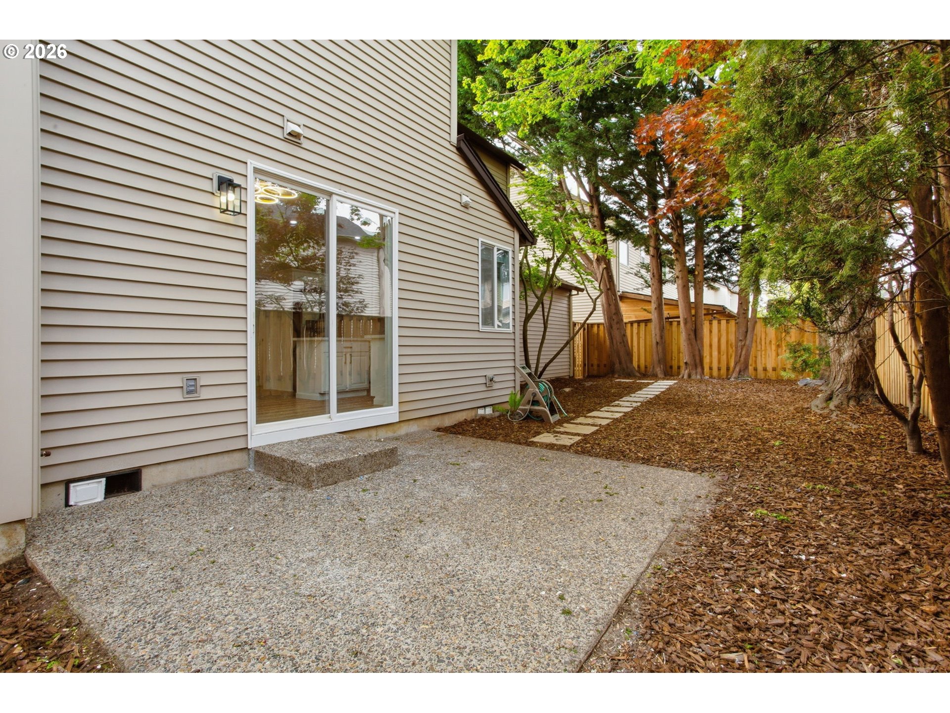 8911 Southwest Gravenstein Lane Tigard, OR 97224 - Photo 30 of 33 a view of a backyard with a large tree