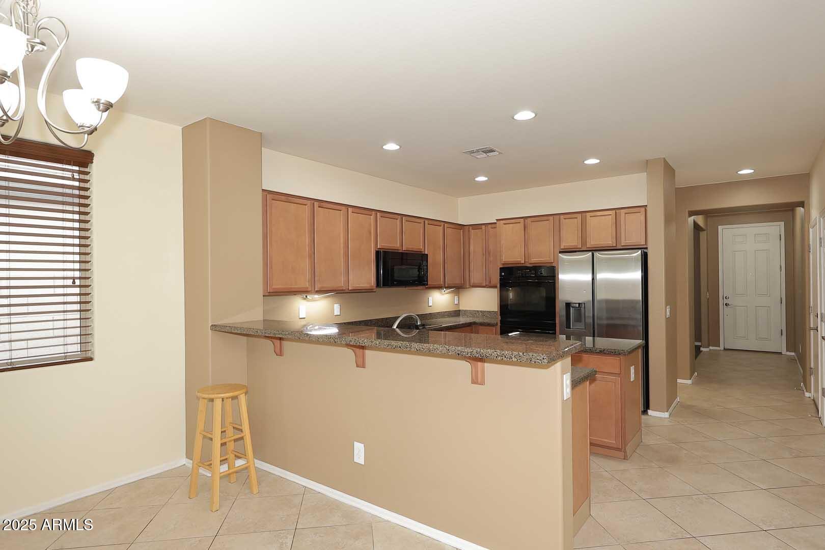 11020 East Shepperd Avenue Mesa, AZ 85212 - Photo 11 of 37 a kitchen with stainless steel appliances a refrigerator sink and microwave