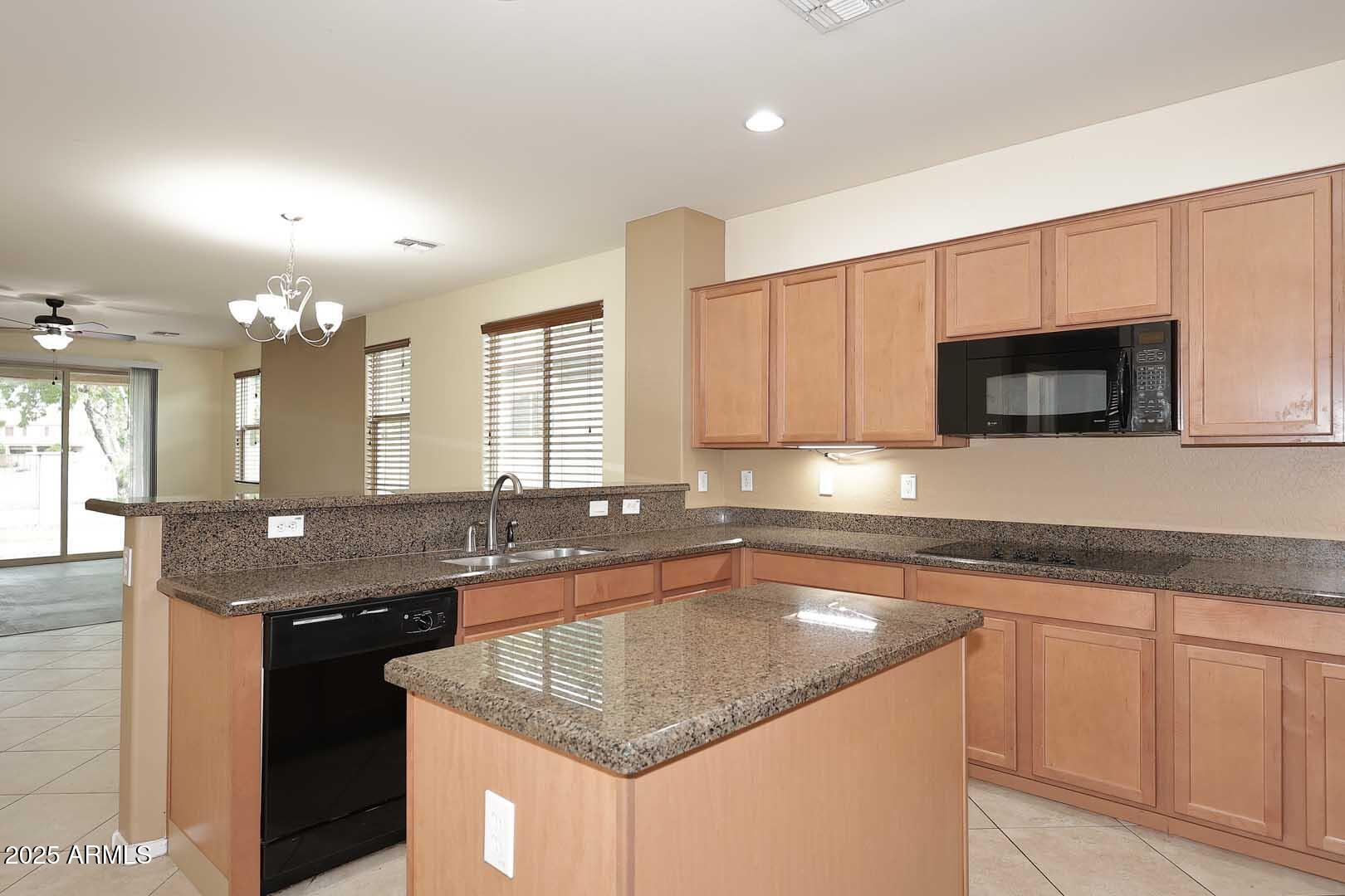 11020 East Shepperd Avenue Mesa, AZ 85212 - Photo 13 of 37 a kitchen with granite countertop a sink and a stove