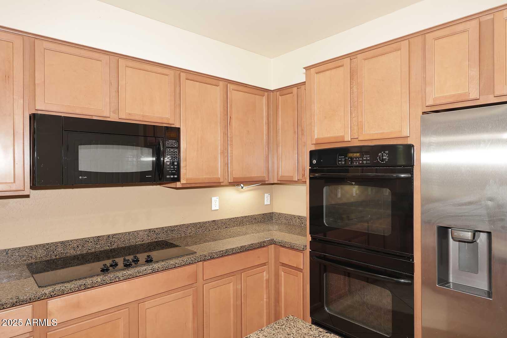 11020 East Shepperd Avenue Mesa, AZ 85212 - Photo 14 of 37 a kitchen with granite countertop white cabinets and stainless steel appliances