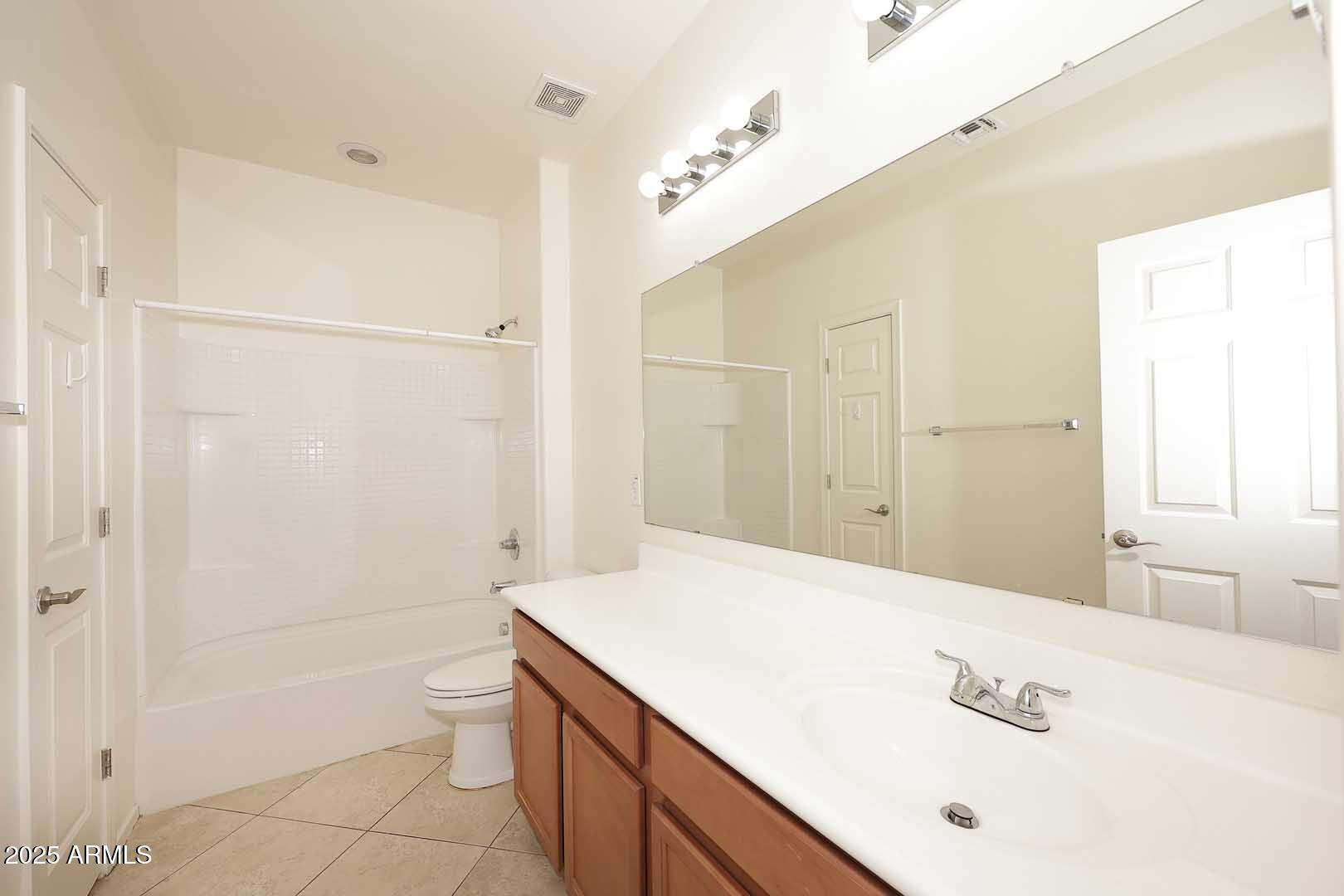 11020 East Shepperd Avenue Mesa, AZ 85212 - Photo 17 of 37 a bathroom with a granite countertop sink a toilet and shower