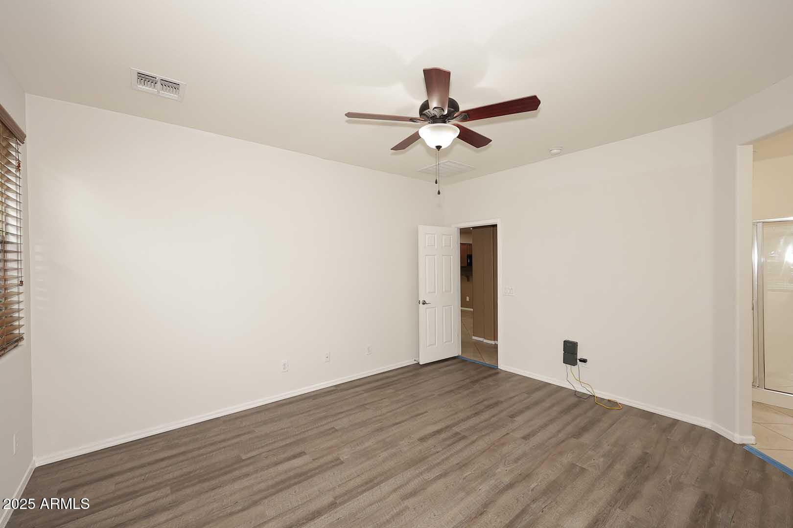 11020 East Shepperd Avenue Mesa, AZ 85212 - Photo 24 of 37 a view of room with hardwood floor and a ceiling fan