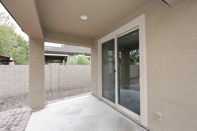 a view of a hallway with wooden floor and a living room