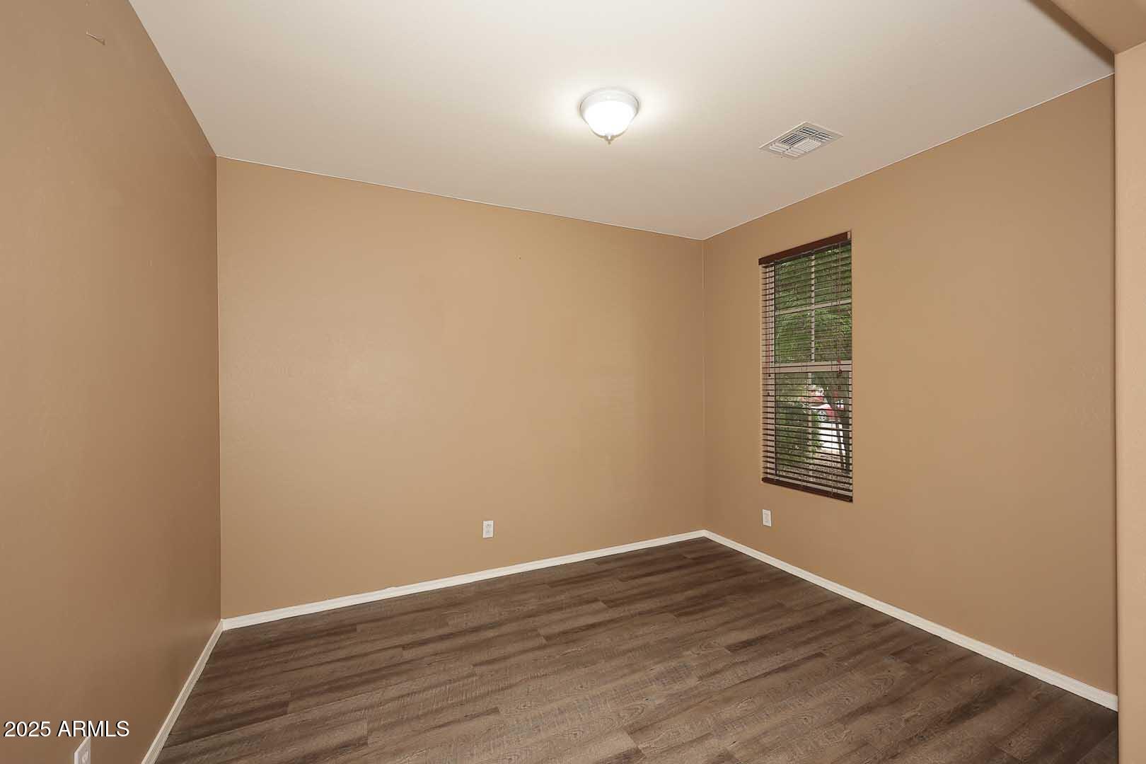 11020 East Shepperd Avenue Mesa, AZ 85212 - Photo 5 of 37 a view of an empty room with wooden floor and a window