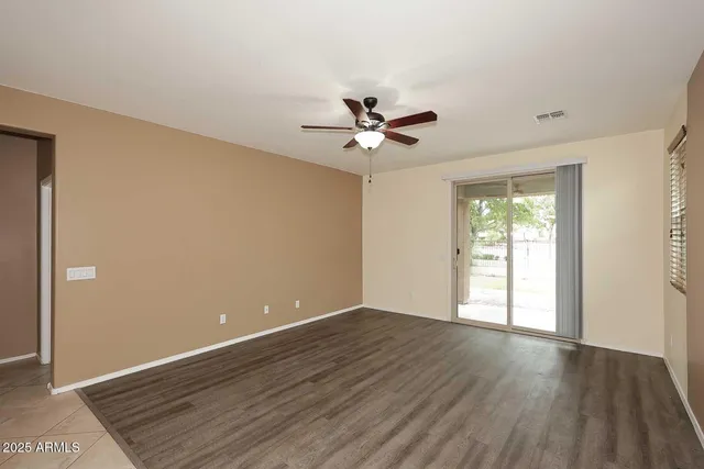 a view of a livingroom with a hardwood floor and a ceiling fan