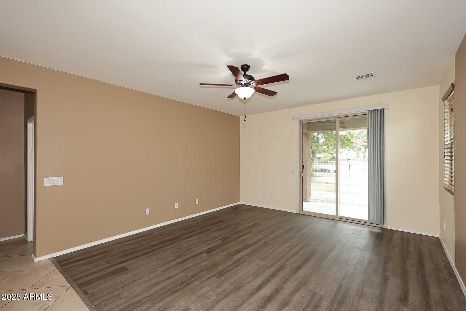 11020 East Shepperd Avenue Mesa, AZ 85212 - Photo 7 of 37 an empty room with wooden floor and windows