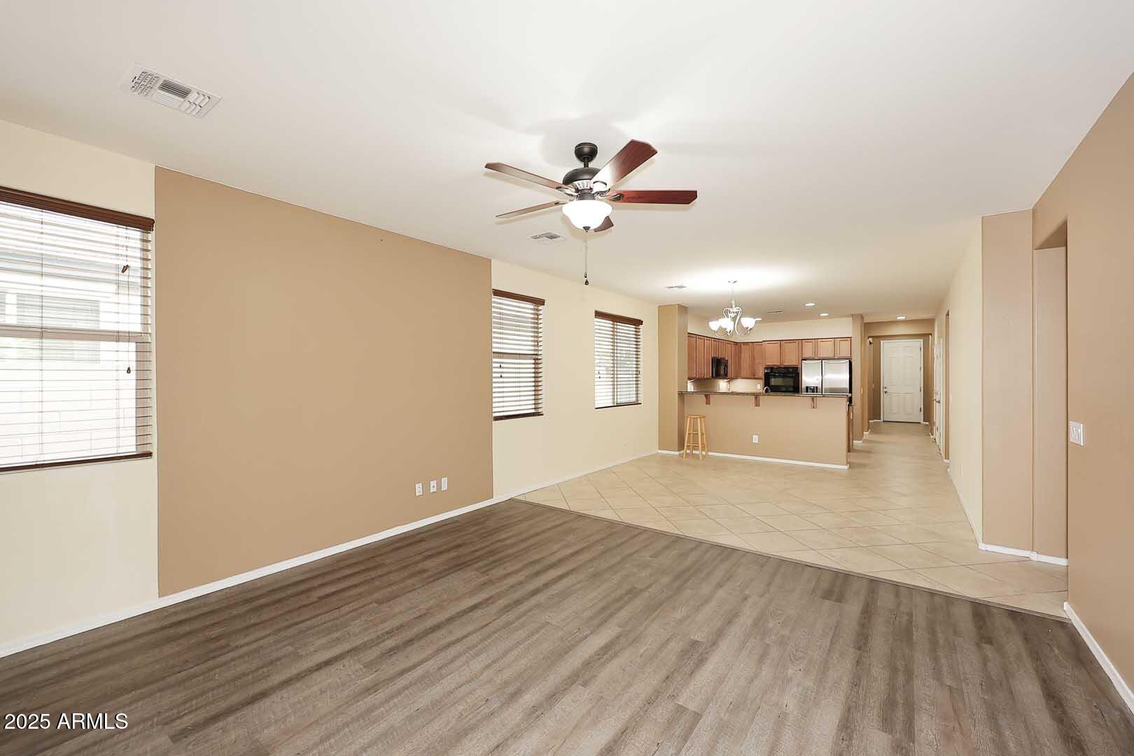 11020 East Shepperd Avenue Mesa, AZ 85212 - Photo 8 of 37 a view of a livingroom with a hardwood floor and a ceiling fan