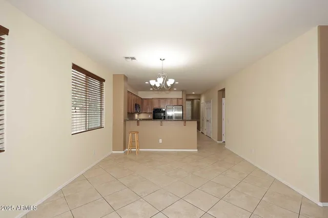 a kitchen with stainless steel appliances a refrigerator sink and microwave