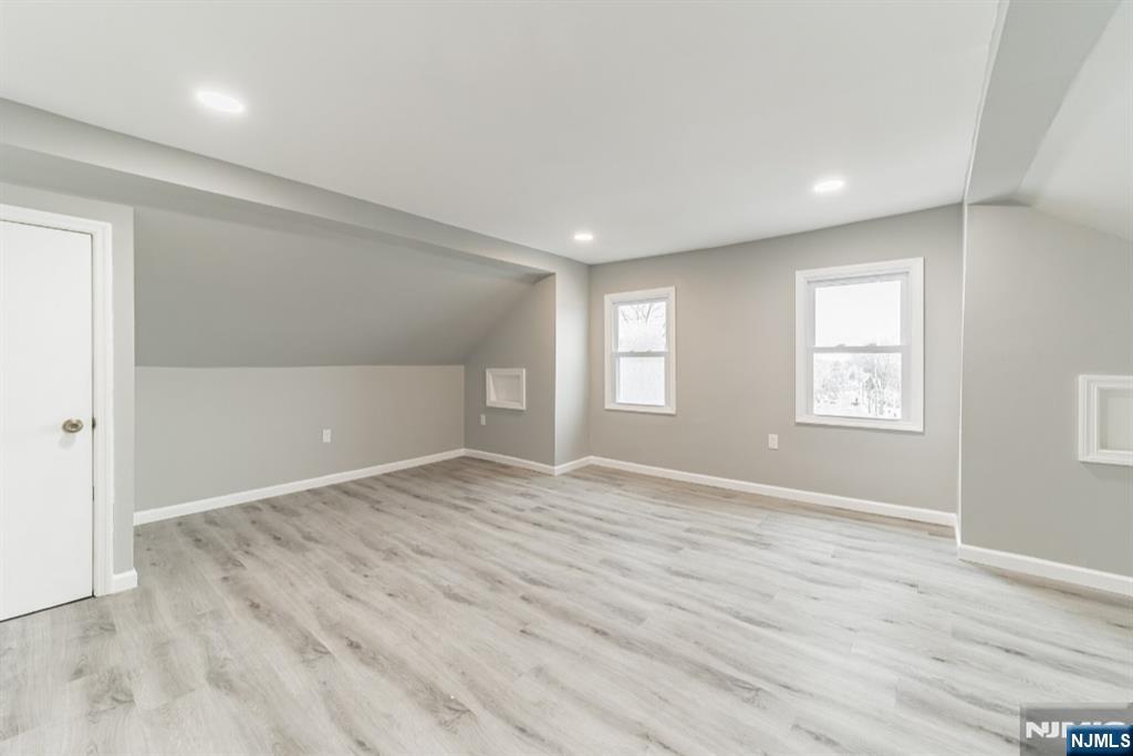 15 South Prospect Street, Unit B Verona, NJ 07044 - Photo 13 of 15 a view of an empty room with wooden floor and a window