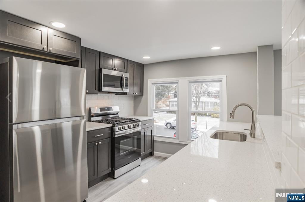 15 South Prospect Street, Unit B Verona, NJ 07044 - Photo 4 of 15 a kitchen with stainless steel appliances a refrigerator sink and microwave