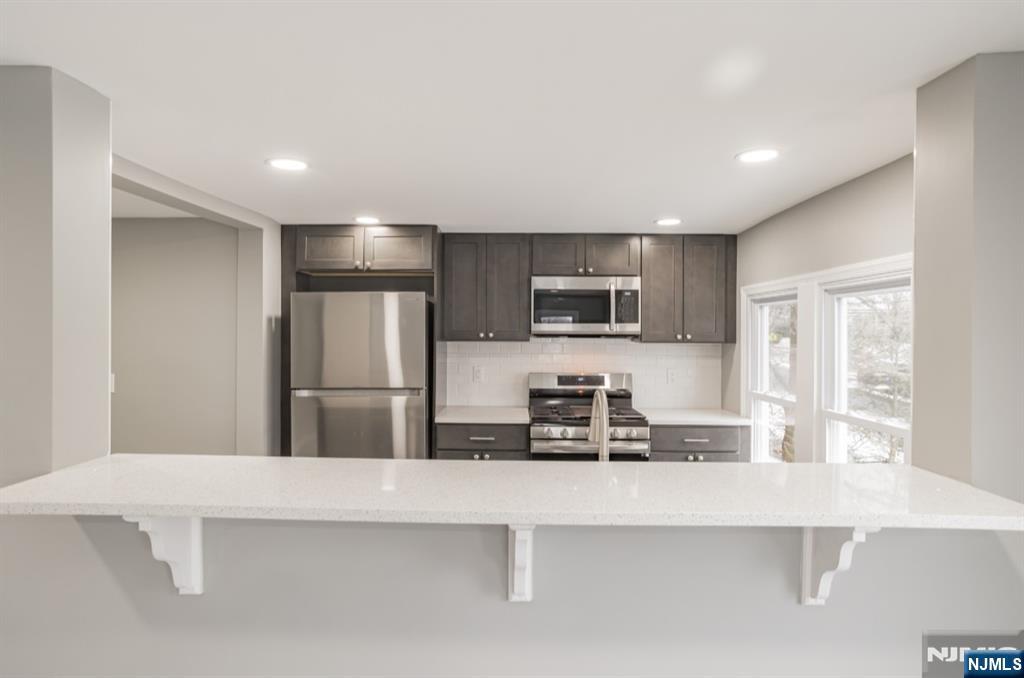 15 South Prospect Street, Unit B Verona, NJ 07044 - Photo 5 of 15 a kitchen with stainless steel appliances a refrigerator sink and microwave
