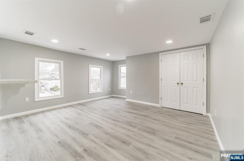 15 South Prospect Street, Unit B Verona, NJ 07044 - Photo 7 of 15 an empty room with wooden floor and windows