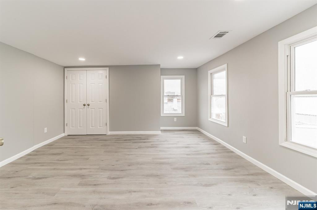 15 South Prospect Street, Unit B Verona, NJ 07044 - Photo 8 of 15 wooden floor in an empty room with a window