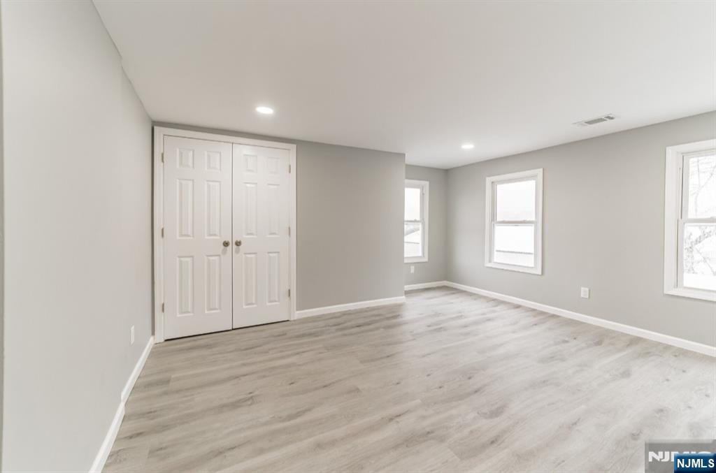 15 South Prospect Street, Unit B Verona, NJ 07044 - Photo 10 of 15 a view of an empty room with wooden floor and a window