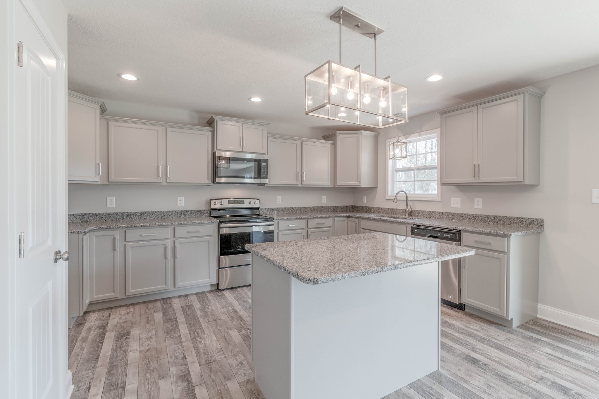 1688 Rains Road Clarksville, TN 37042 - Photo 11 of 32 a kitchen with kitchen island granite countertop a sink cabinets and stainless steel appliances