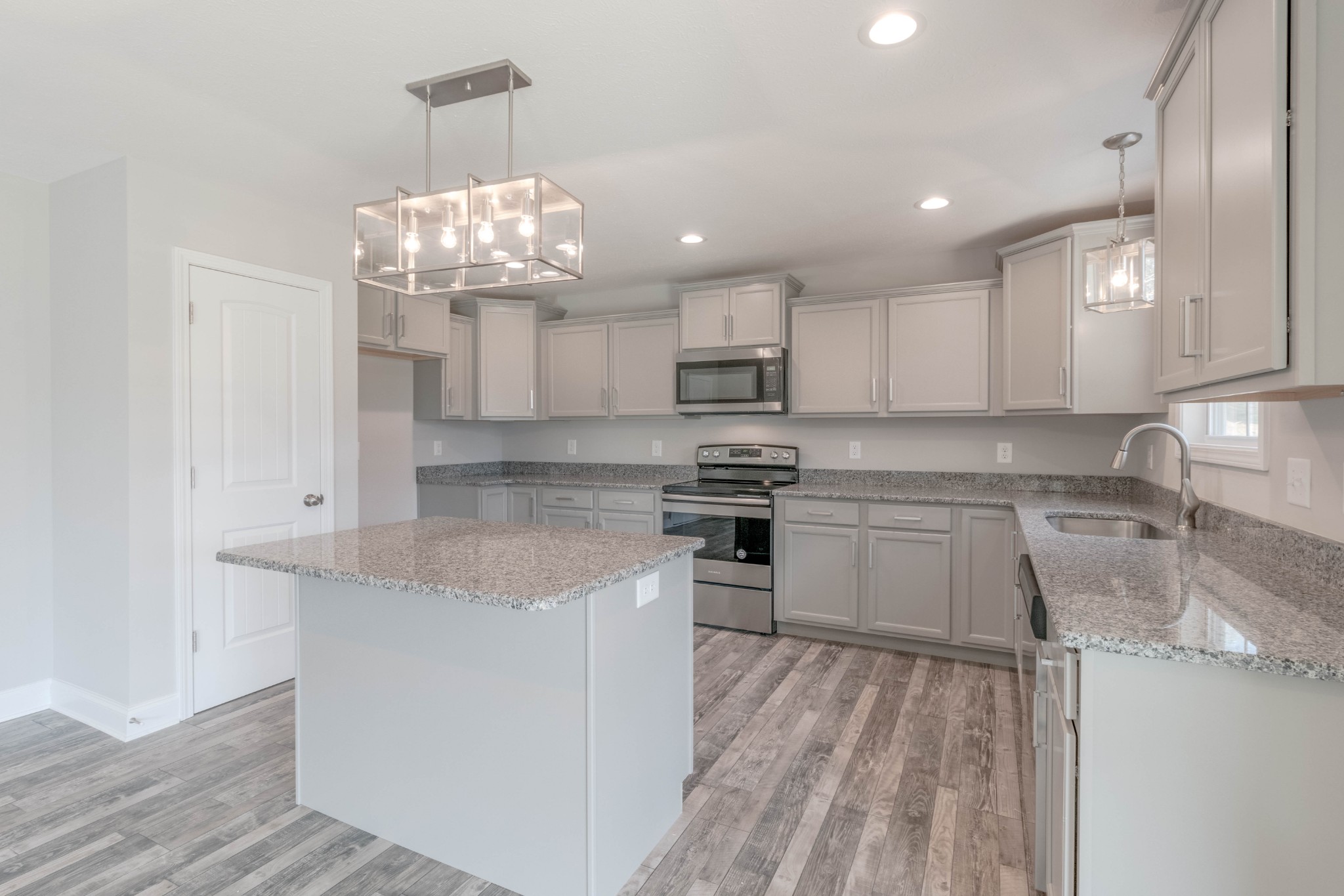 1688 Rains Road Clarksville, TN 37042 - Photo 12 of 32 a kitchen with kitchen island granite countertop stainless steel appliances a sink stove top oven and cabinets