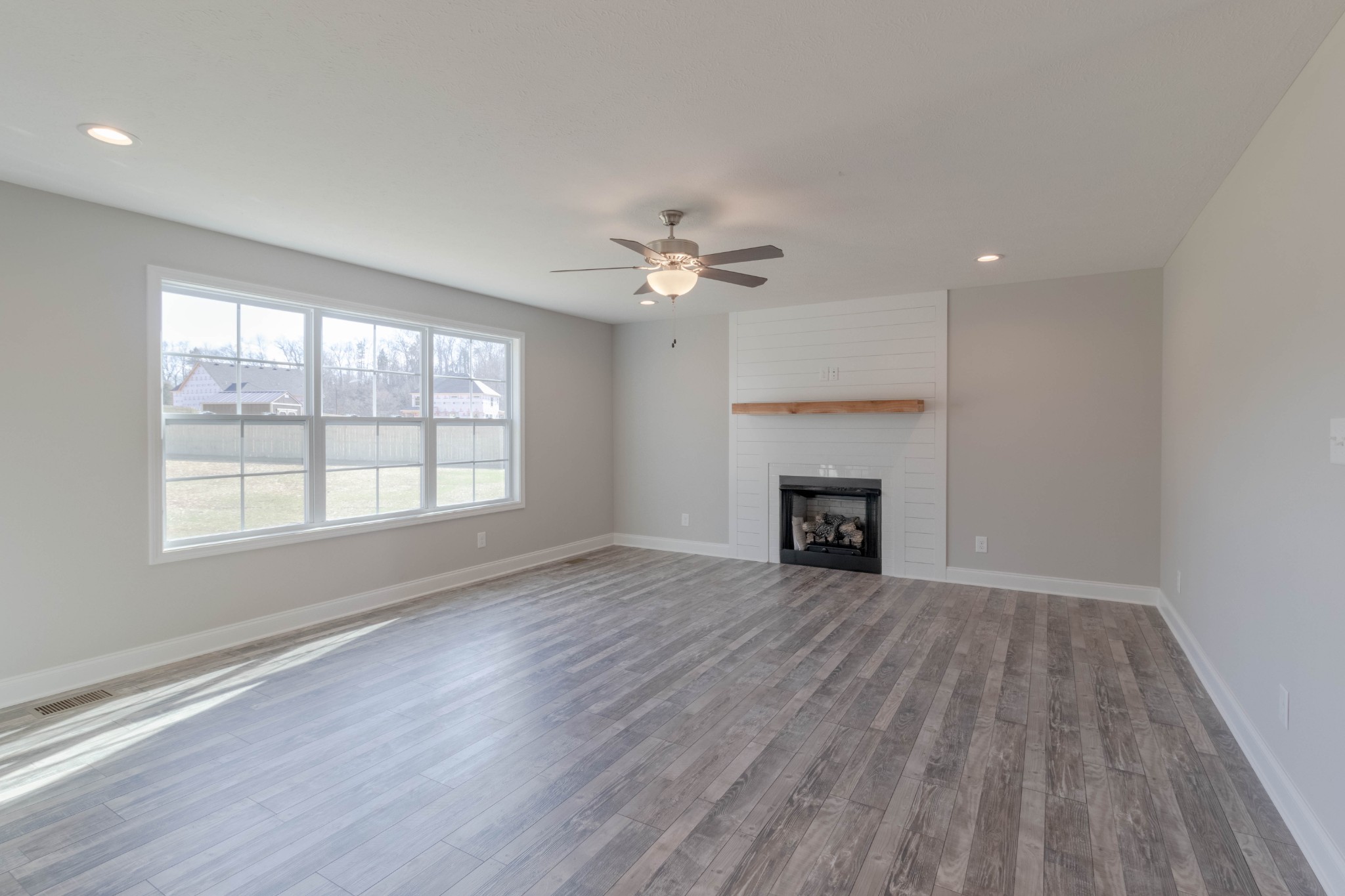 1688 Rains Road Clarksville, TN 37042 - Photo 5 of 32 wooden floor fireplace and windows in an empty room