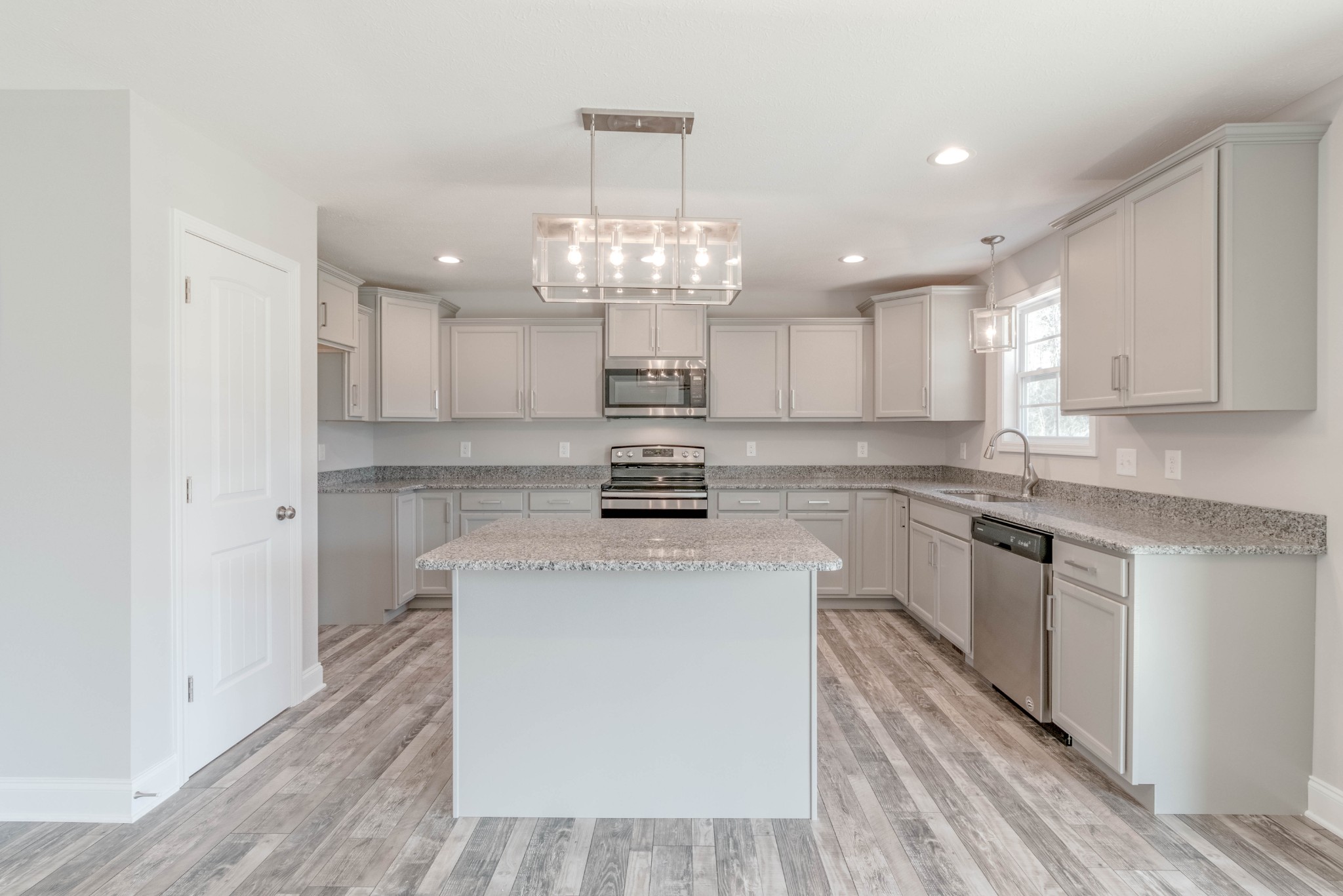 1688 Rains Road Clarksville, TN 37042 - Photo 10 of 32 a kitchen with kitchen island granite countertop a sink cabinets and stainless steel appliances