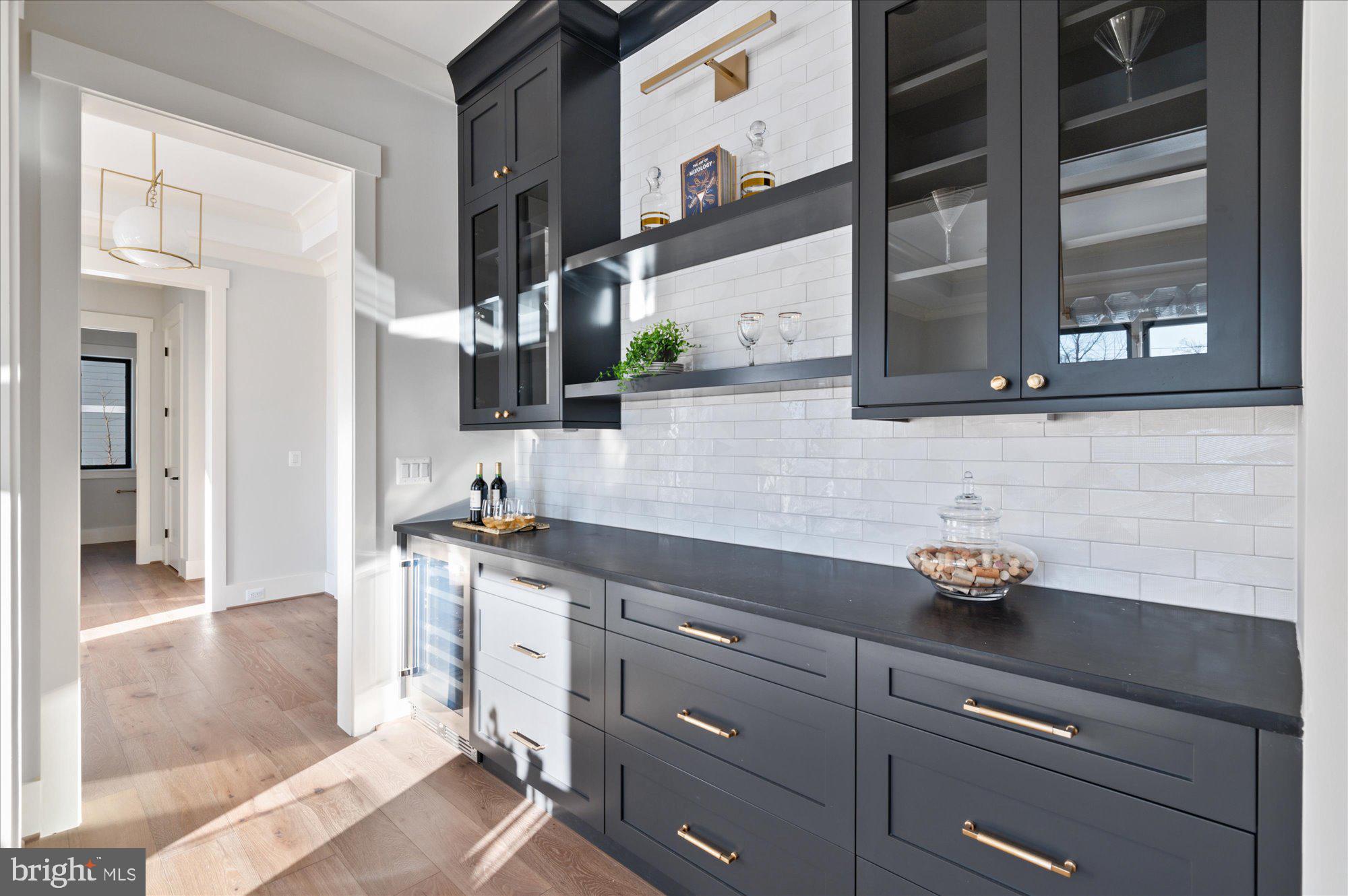 6928 Whitehall Place McLean, VA 22101 - Photo 20 of 77 a kitchen with stainless steel appliances granite countertop a sink a stove and a wooden floors