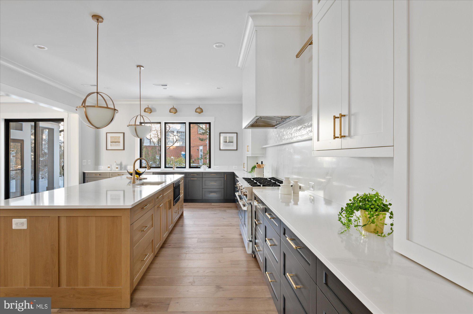 6928 Whitehall Place McLean, VA 22101 - Photo 37 of 77 a spacious kitchen with stainless steel appliances granite countertop a lot of counter space and a wooden floor