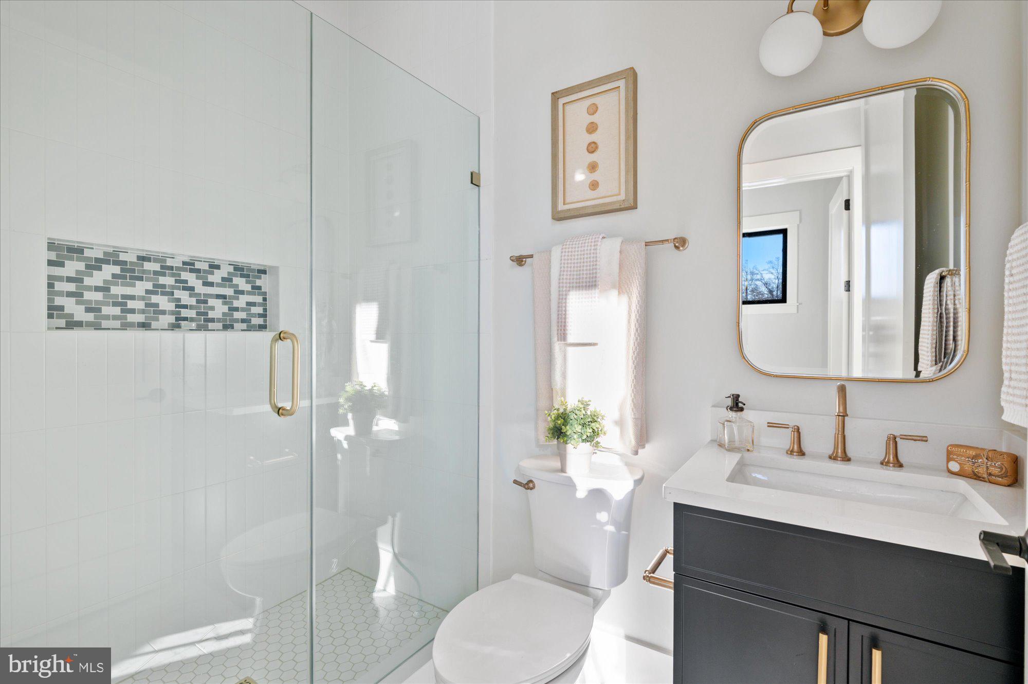 6928 Whitehall Place McLean, VA 22101 - Photo 46 of 77 a bathroom with a granite countertop sink mirror a toilet and shower