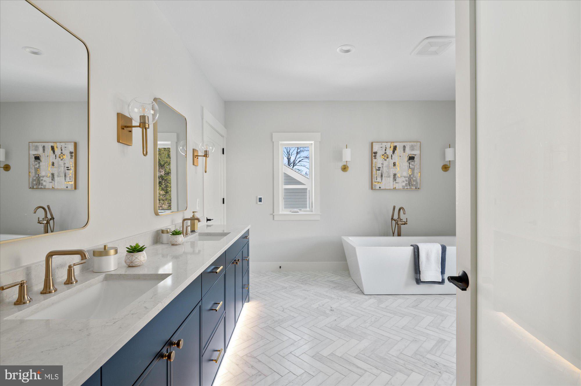6928 Whitehall Place McLean, VA 22101 - Photo 53 of 77 a en suite bathroom with a double vanity sink a mirror and a bathtub