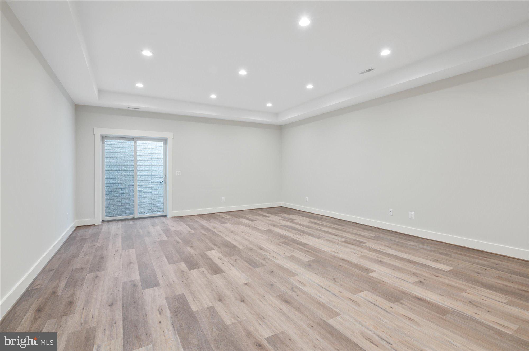 6928 Whitehall Place McLean, VA 22101 - Photo 66 of 77 an empty room with wooden floor and natural light