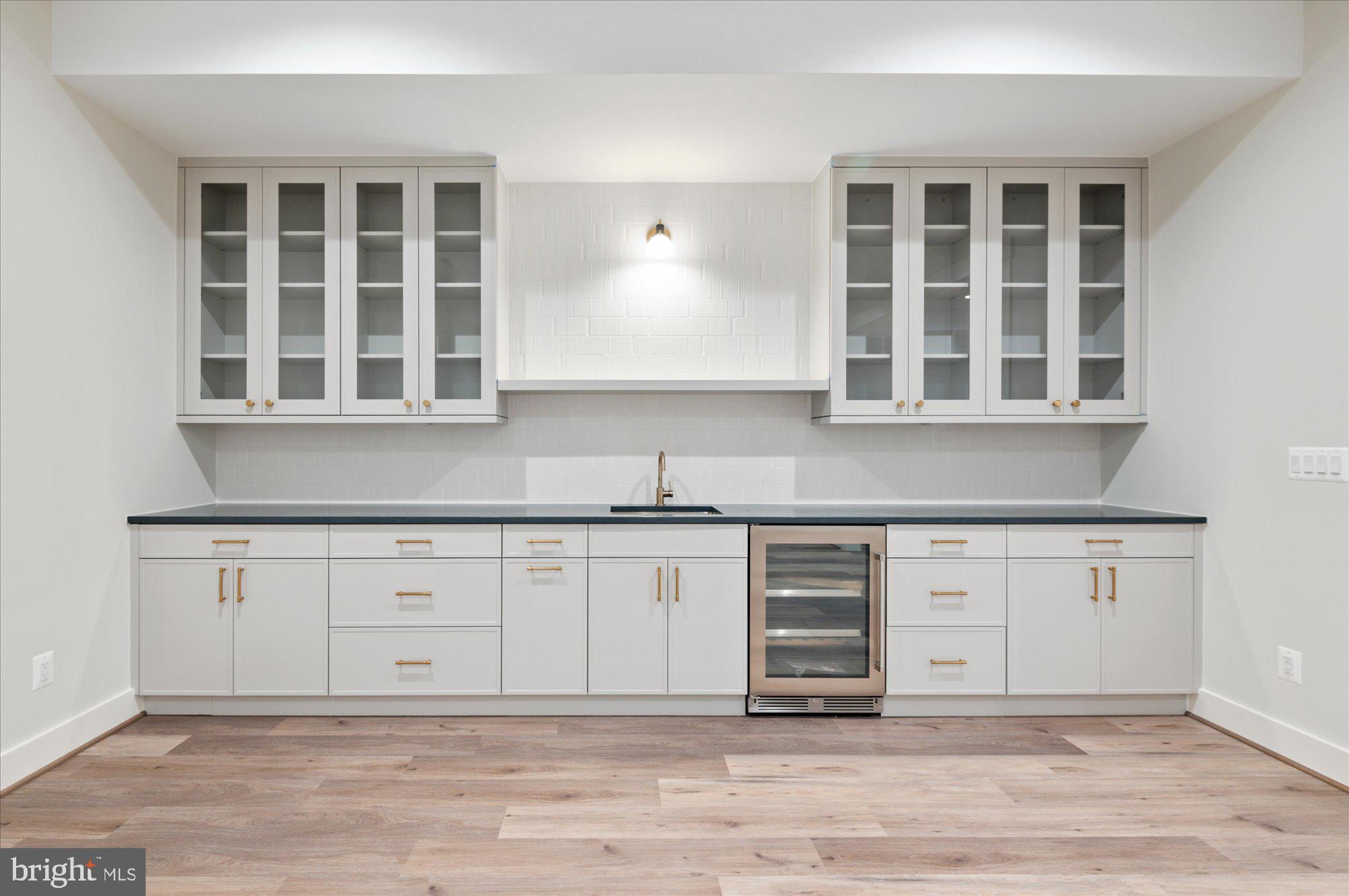 6928 Whitehall Place McLean, VA 22101 - Photo 71 of 77 a kitchen with granite countertop a stove sink and cabinets
