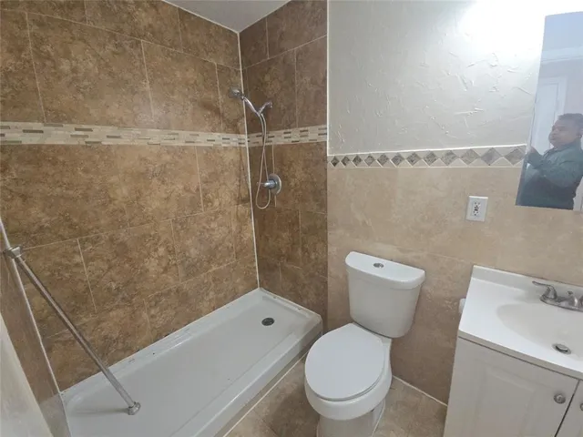 a white toilet and a shower