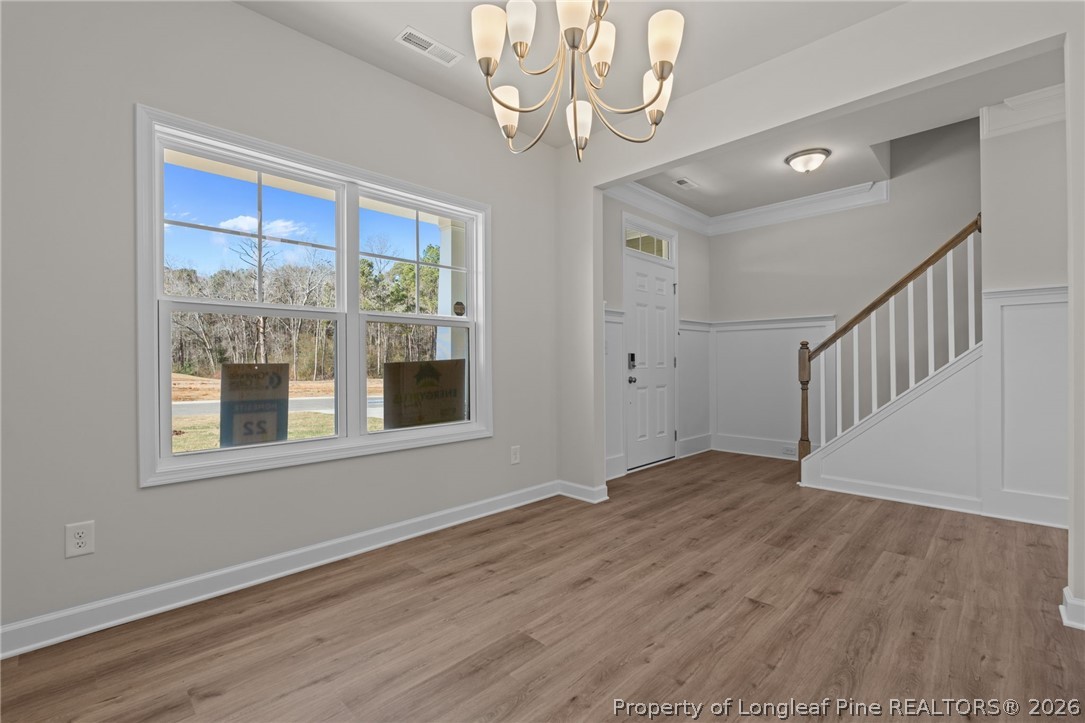 290 Elijah Way Vass, NC 28394 - Photo 12 of 45 a view of an empty room with wooden floor and a window