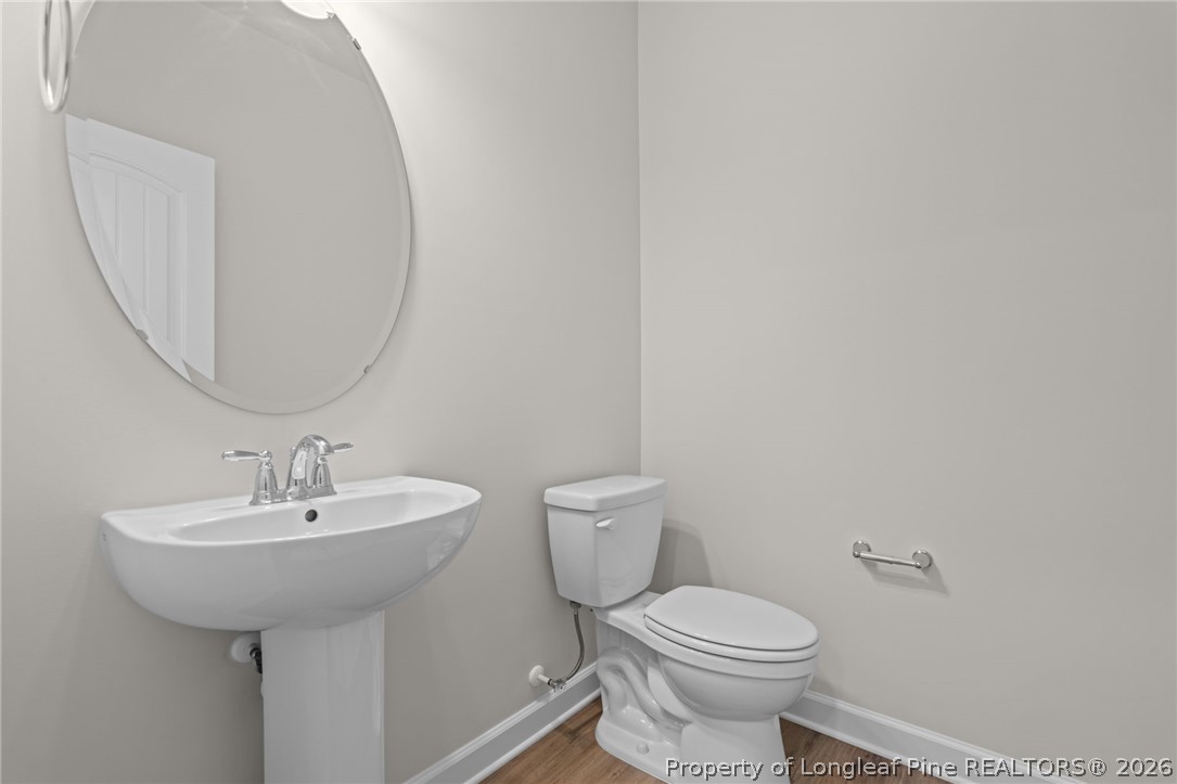 290 Elijah Way Vass, NC 28394 - Photo 13 of 45 a bathroom with a toilet sink and mirror