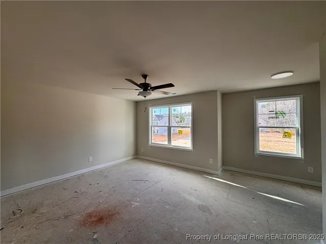 a view of a livingroom with a ceiling fan and window
