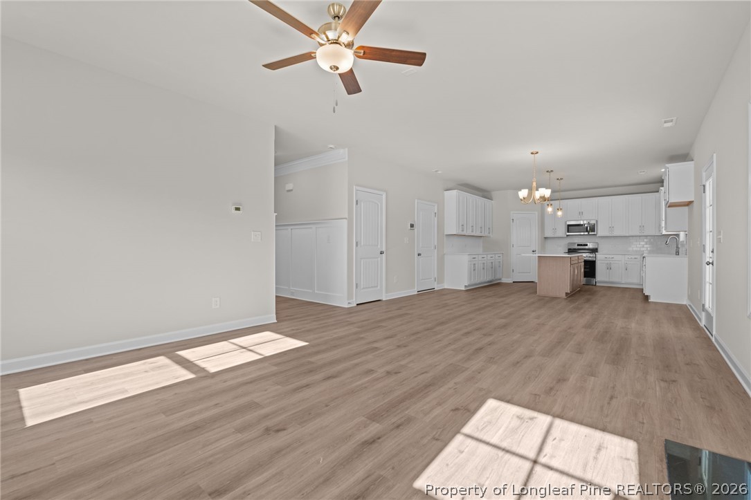 290 Elijah Way Vass, NC 28394 - Photo 17 of 45 a view of empty room with wooden floor and fan