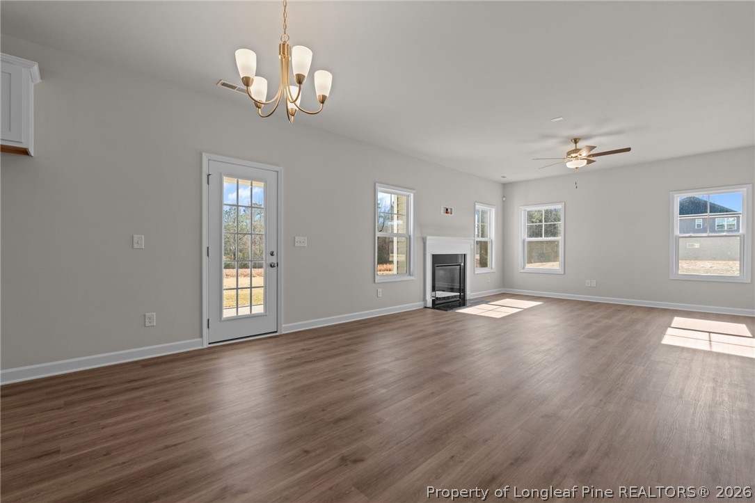 290 Elijah Way Vass, NC 28394 - Photo 19 of 45 a view of an empty room with wooden floor and a window