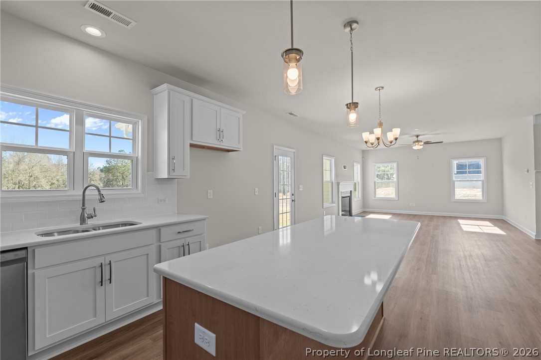 290 Elijah Way Vass, NC 28394 - Photo 24 of 45 a view of a kitchen cabinets a sink dishwasher with a dining table and chairs