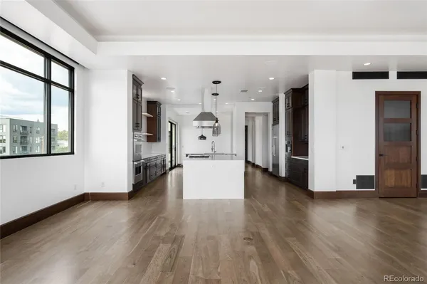 a view of an entryway with wooden floor and windows